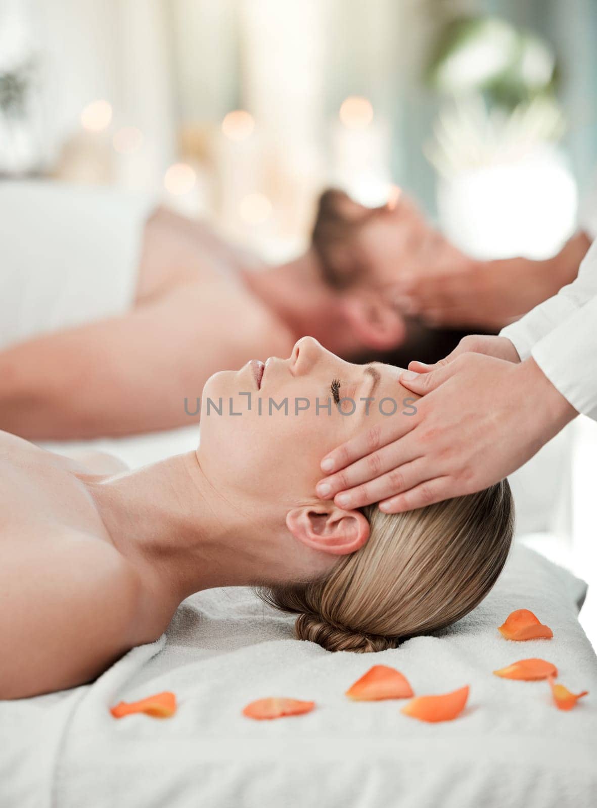 Couple, head massage or relax wellness in hotel, hospitality salon or zen spa in stress release, relax or self care. Reiki hands, man or woman on table bed for peace, headache relief or healthy sleep by YuriArcurs
