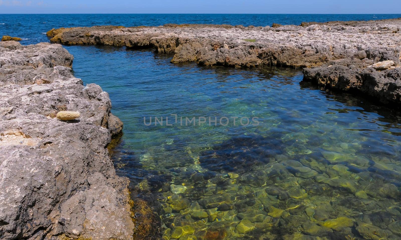 Karst cavity failure in the rocky shore, flooded by water in the eastern Crimea, Black Sea