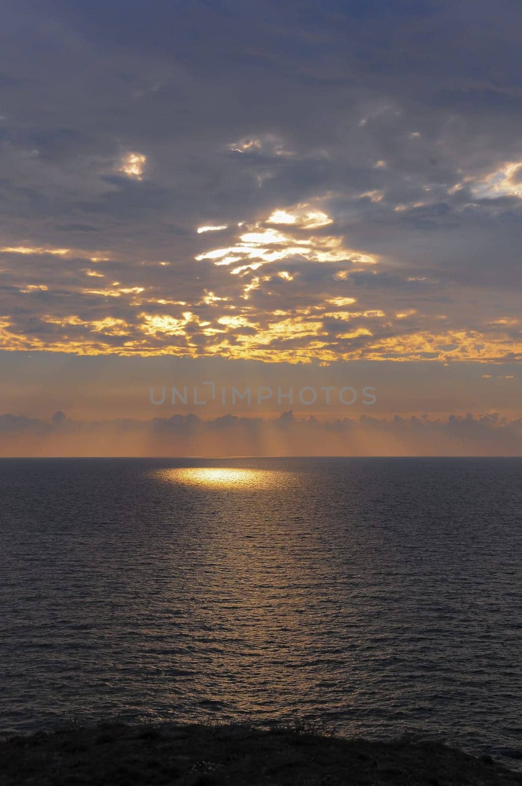 Colorful orange sunrise over the sea, sunbeams in the clouds by Hydrobiolog