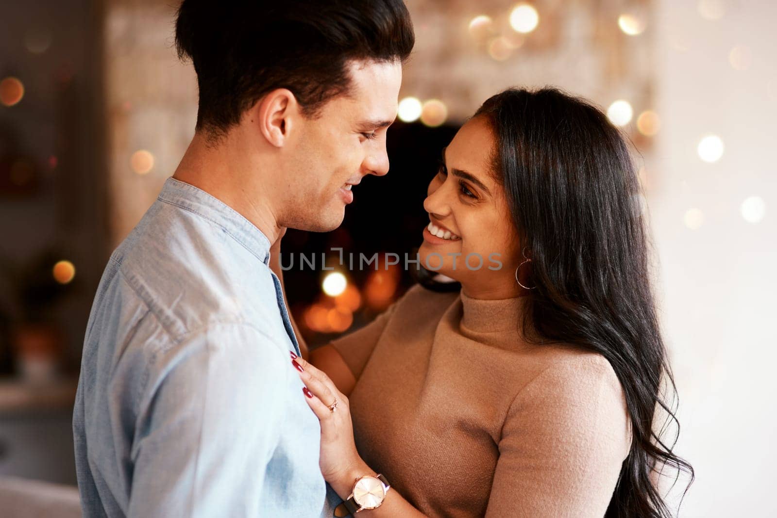 Love, romance and happy couple hugging on a date for valentines day, romantic event or anniversary. Happiness, smile and interracial man and woman embracing after a dinner celebration together