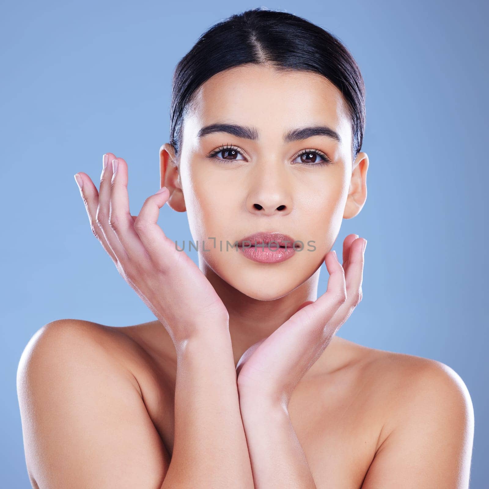 Compete with who No. an attractive young woman posing alone against a blue background in the studio