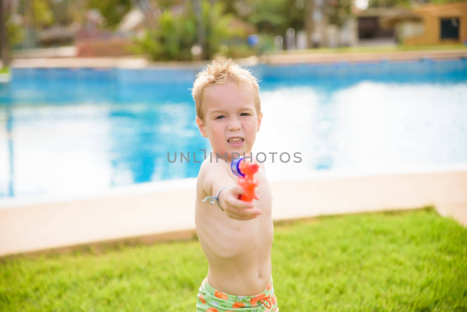 Child playing with water toy in summer.