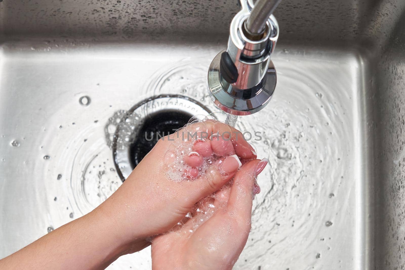Woman washing hands with antibacterial soap for corona virus prevention, hygiene to stop spreading coronavirus by Mariakray