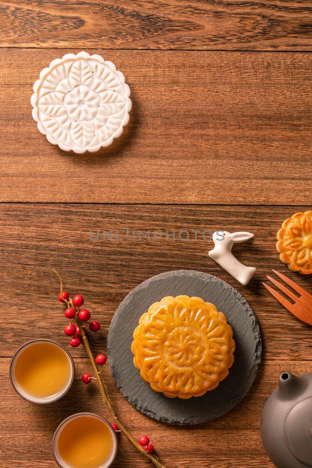 Creative Moon cake Mooncake table design - Chinese traditional pastry with tea cups on wooden background, Mid-Autumn Festival concept, top view, flat lay. by ROMIXIMAGE