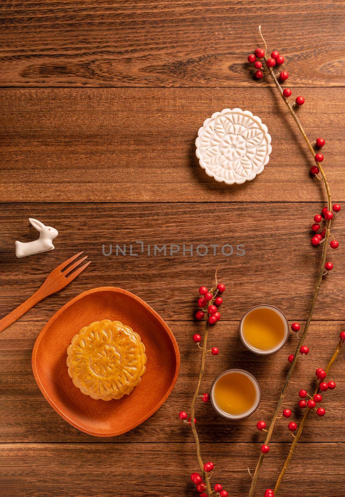 Creative Moon cake Mooncake table design - Chinese traditional pastry with tea cups on wooden background, Mid-Autumn Festival concept, top view, flat lay. by ROMIXIMAGE