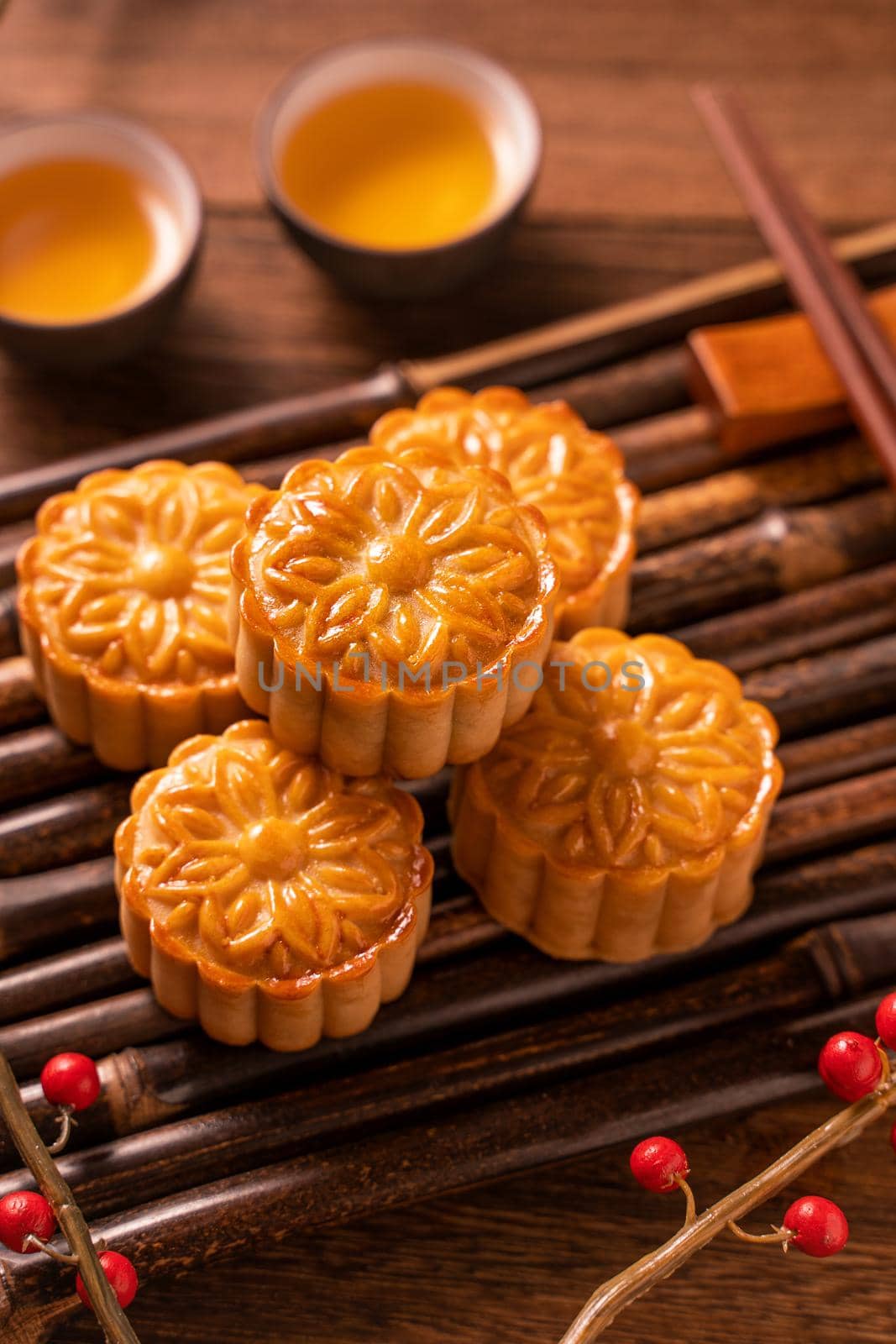 Moon cake Mooncake table setting - Round shaped Chinese traditional pastry with tea cups on wooden background, Mid-Autumn Festival concept, close up. by ROMIXIMAGE