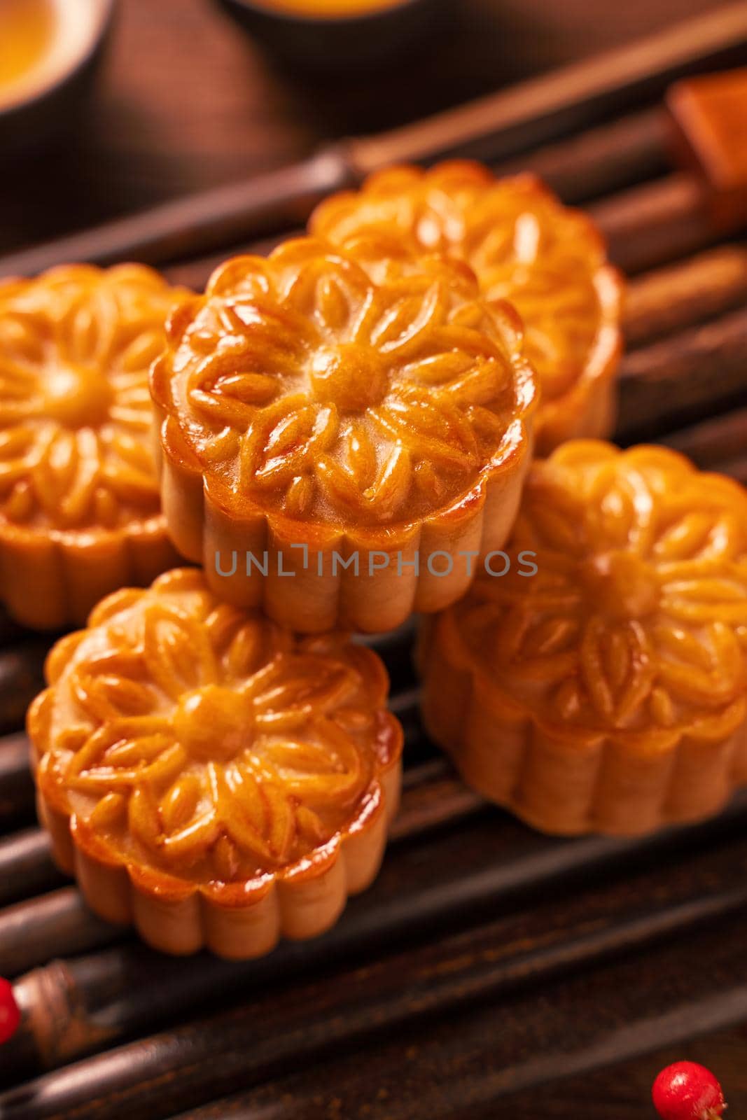 Moon cake Mooncake table setting - Round shaped Chinese traditional pastry with tea cups on wooden background, Mid-Autumn Festival concept, close up. by ROMIXIMAGE