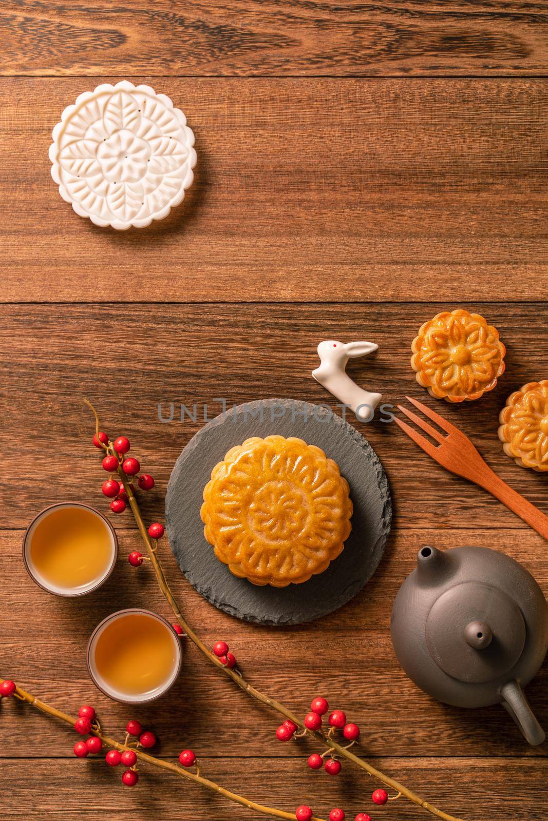 Creative Moon cake Mooncake table design - Chinese traditional pastry with tea cups on wooden background, Mid-Autumn Festival concept, top view, flat lay. by ROMIXIMAGE