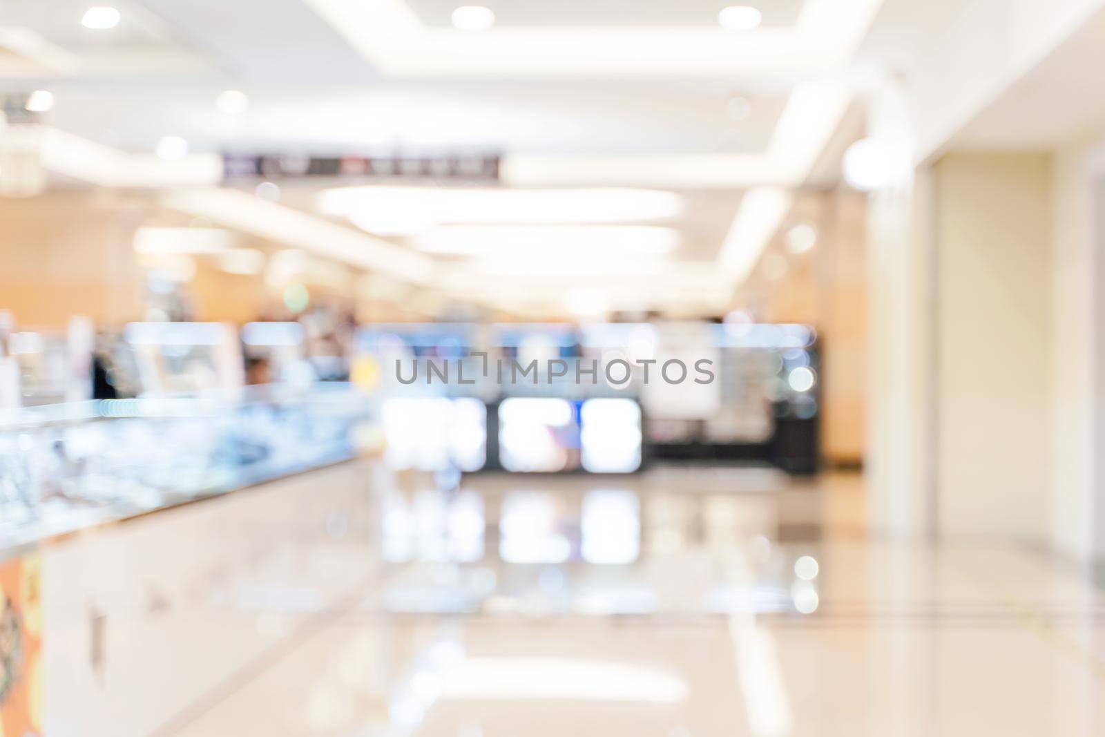 Luxury department store shopping mall interior, abstract defocused blur with bokeh background, concept of shopping seasons design.