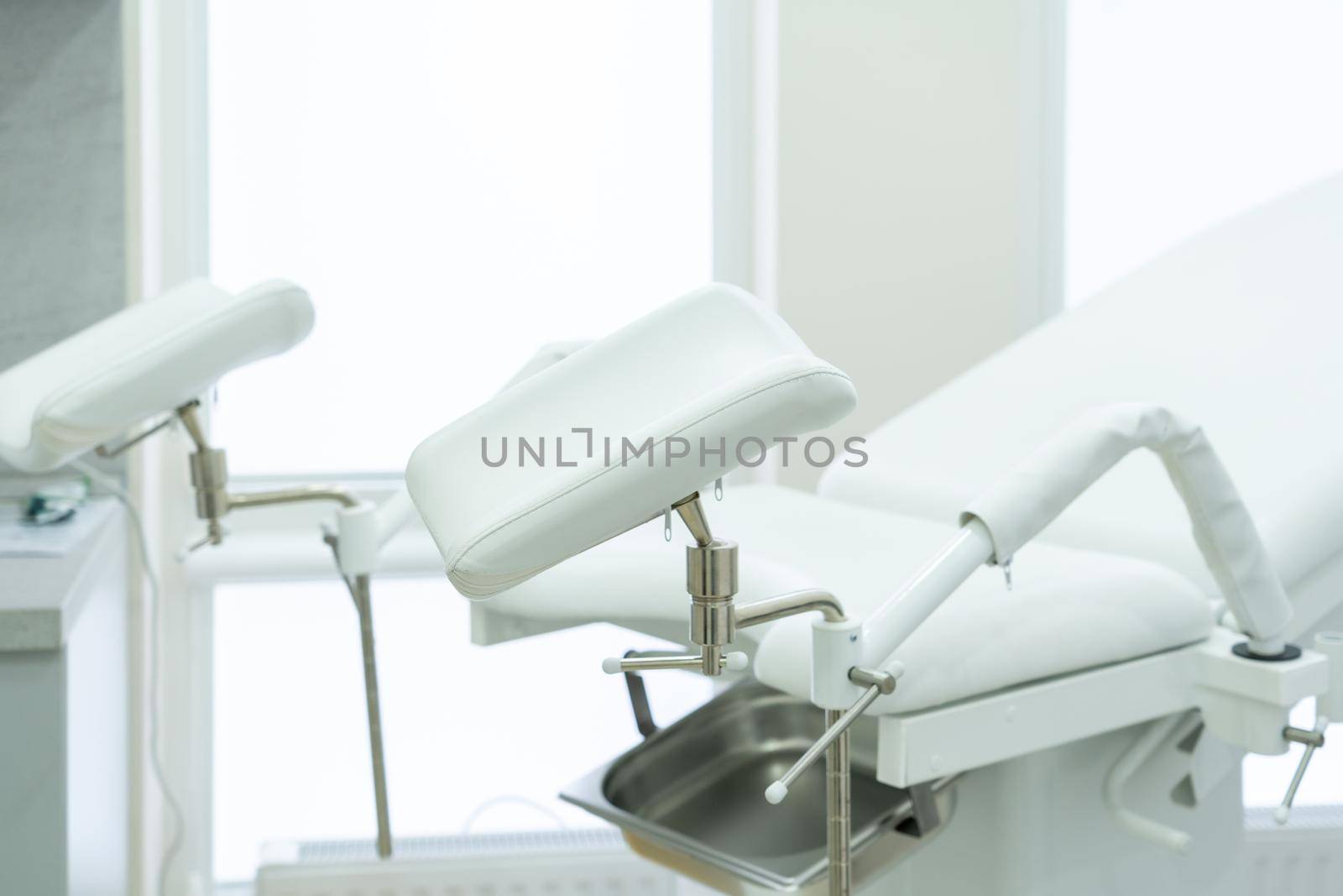 Empty white gynecological chair in a modern medical center