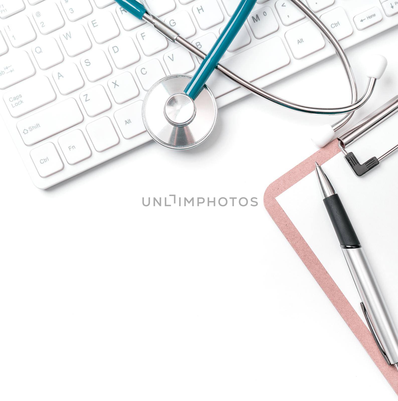 Doctor diagnoses concept - stethoscope on computer keyboard with medical record case and pen on white working table. Top view, flat lay, copy space