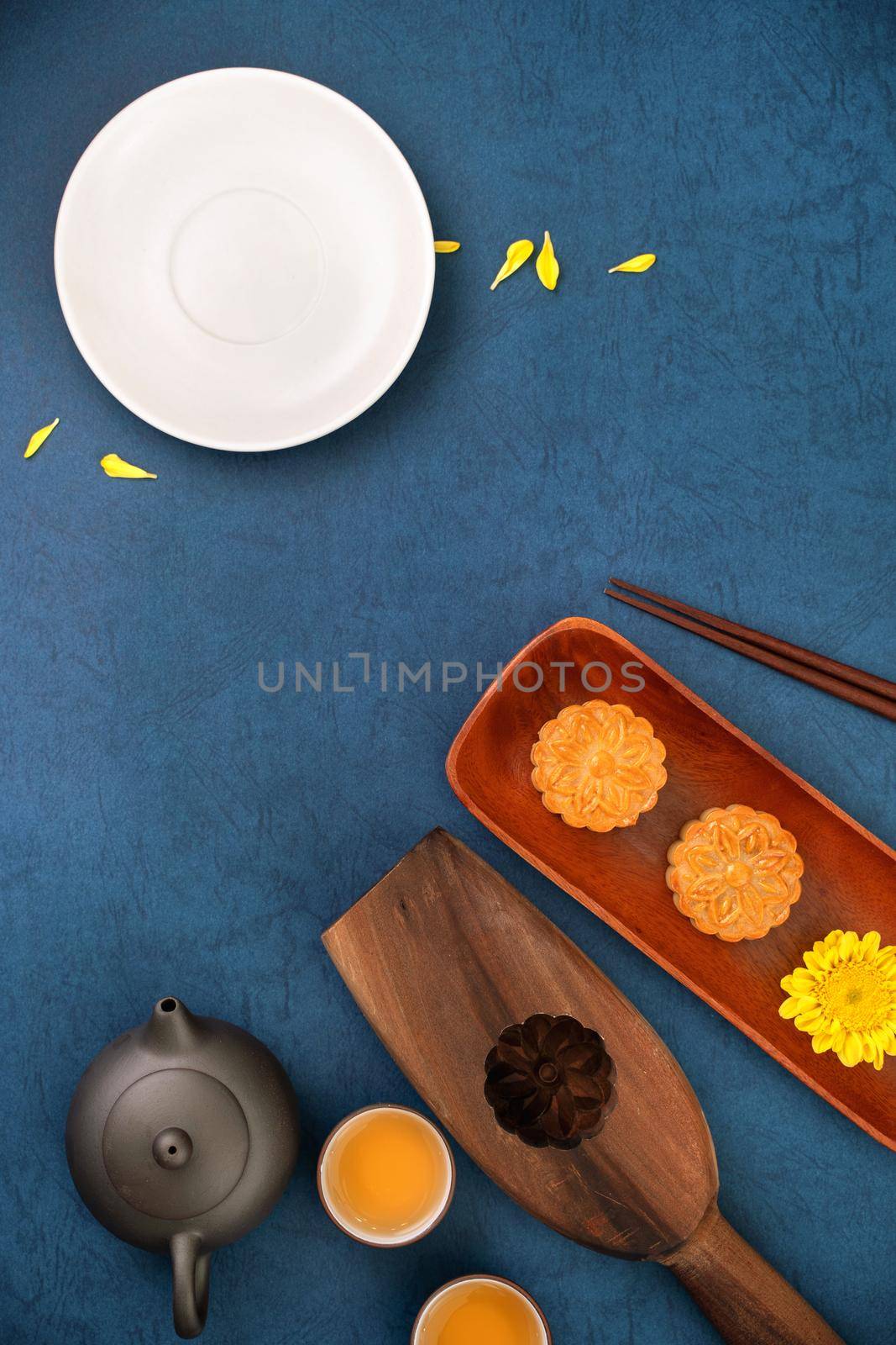 Minimal simplicity layout moon cakes on blue background for Mid-Autumn Festival, creative food design concept, top view, flat lay, copy space.