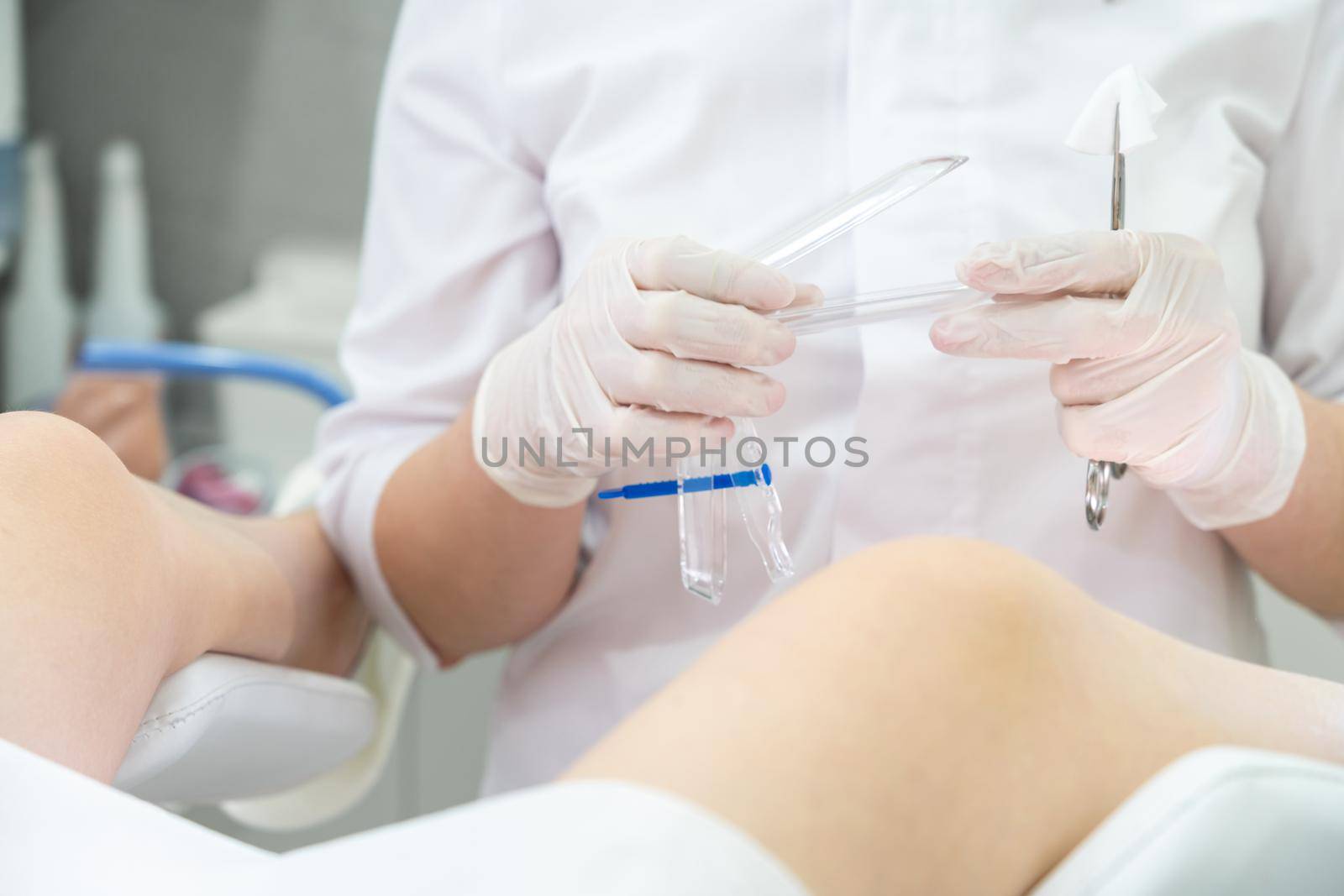 Female gynecologist with vaginal speculum in clinic