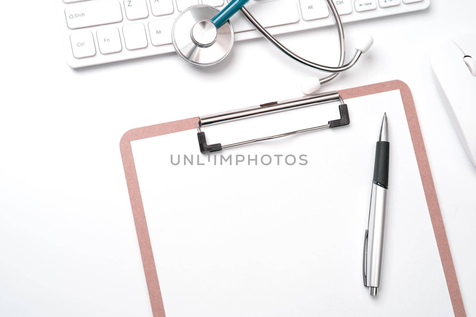 Doctor diagnoses concept - stethoscope on computer keyboard with medical record case and pen on white working table. Top view, flat lay, copy space