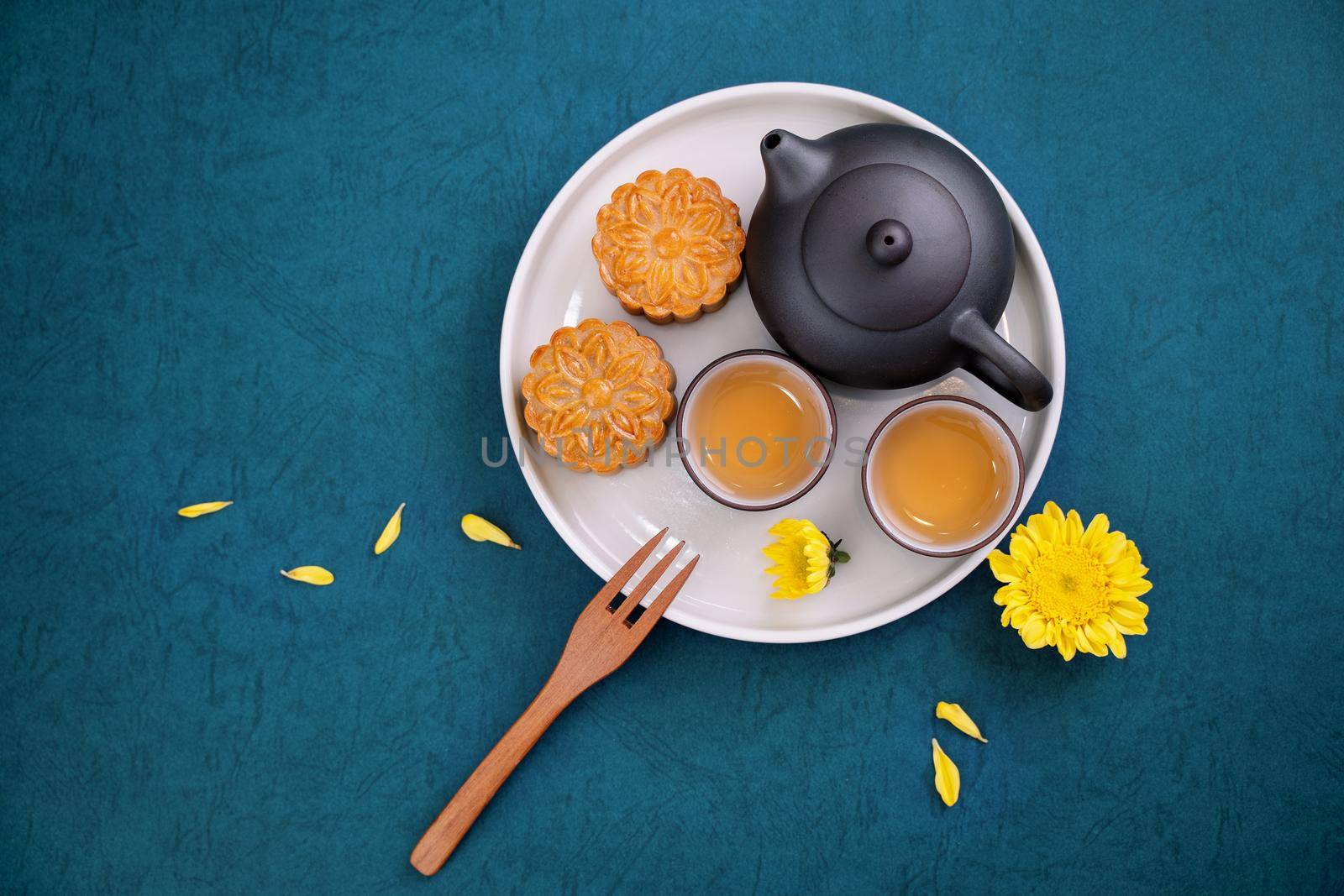 Minimal simplicity layout moon cakes on blue background for Mid-Autumn Festival, creative food design concept, top view, flat lay, copy space.