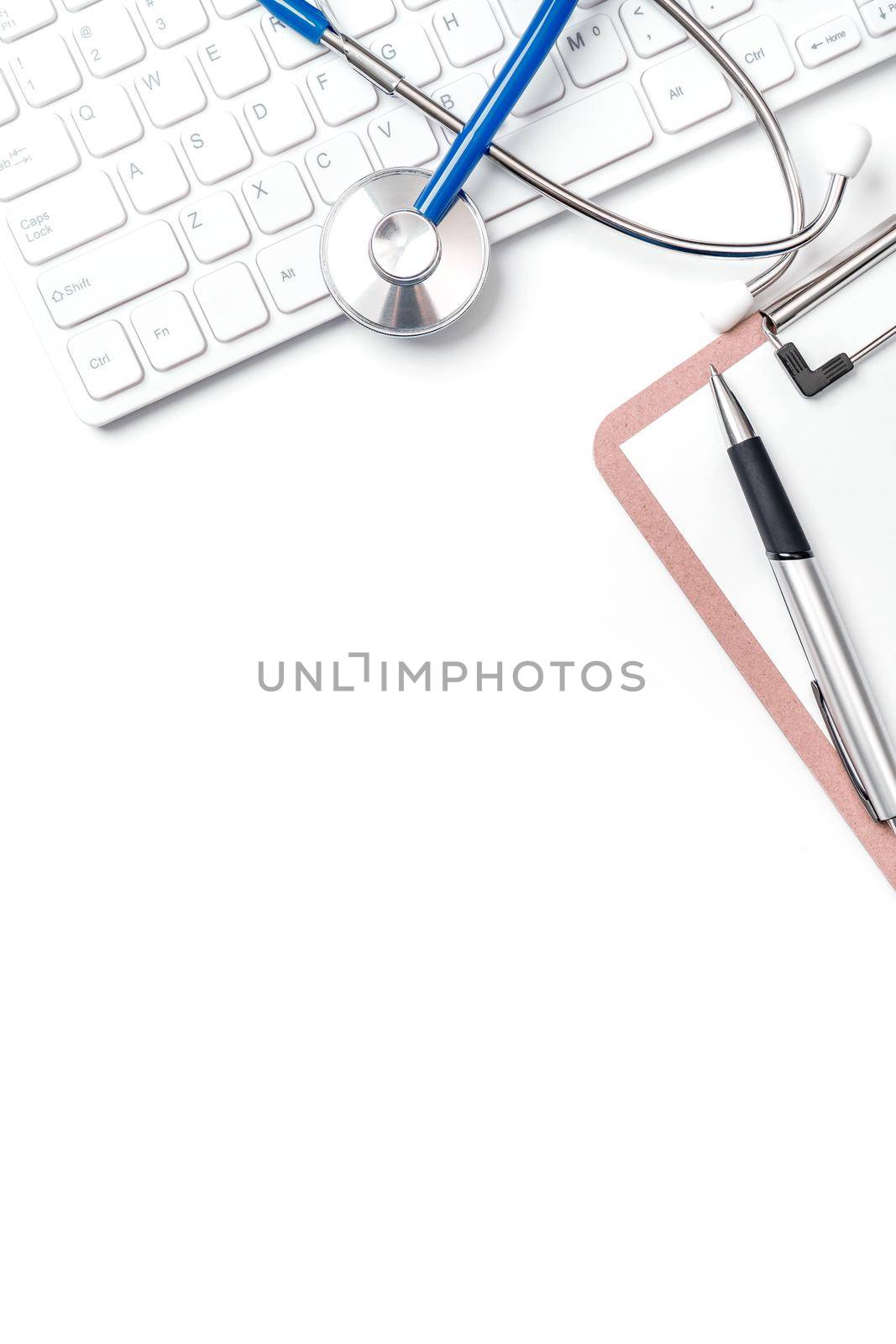 Medical Concept - Stethoscope on computer keyboard on white background. Physician long term care treatment concept. Top view, flat lay, copy space