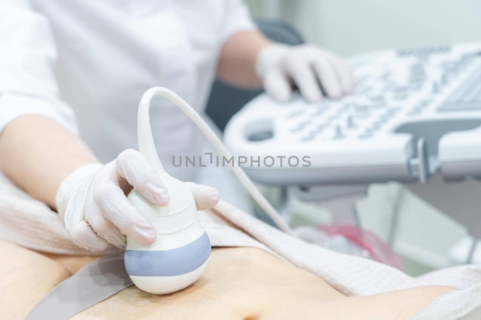 Gynecologist doing ultrasound scan in modern clinic by Mariakray
