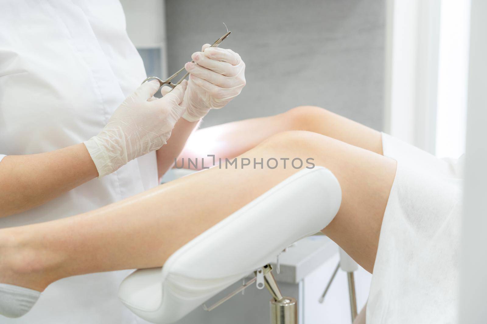 Gynecologist holding needle for stitching before patient surgery