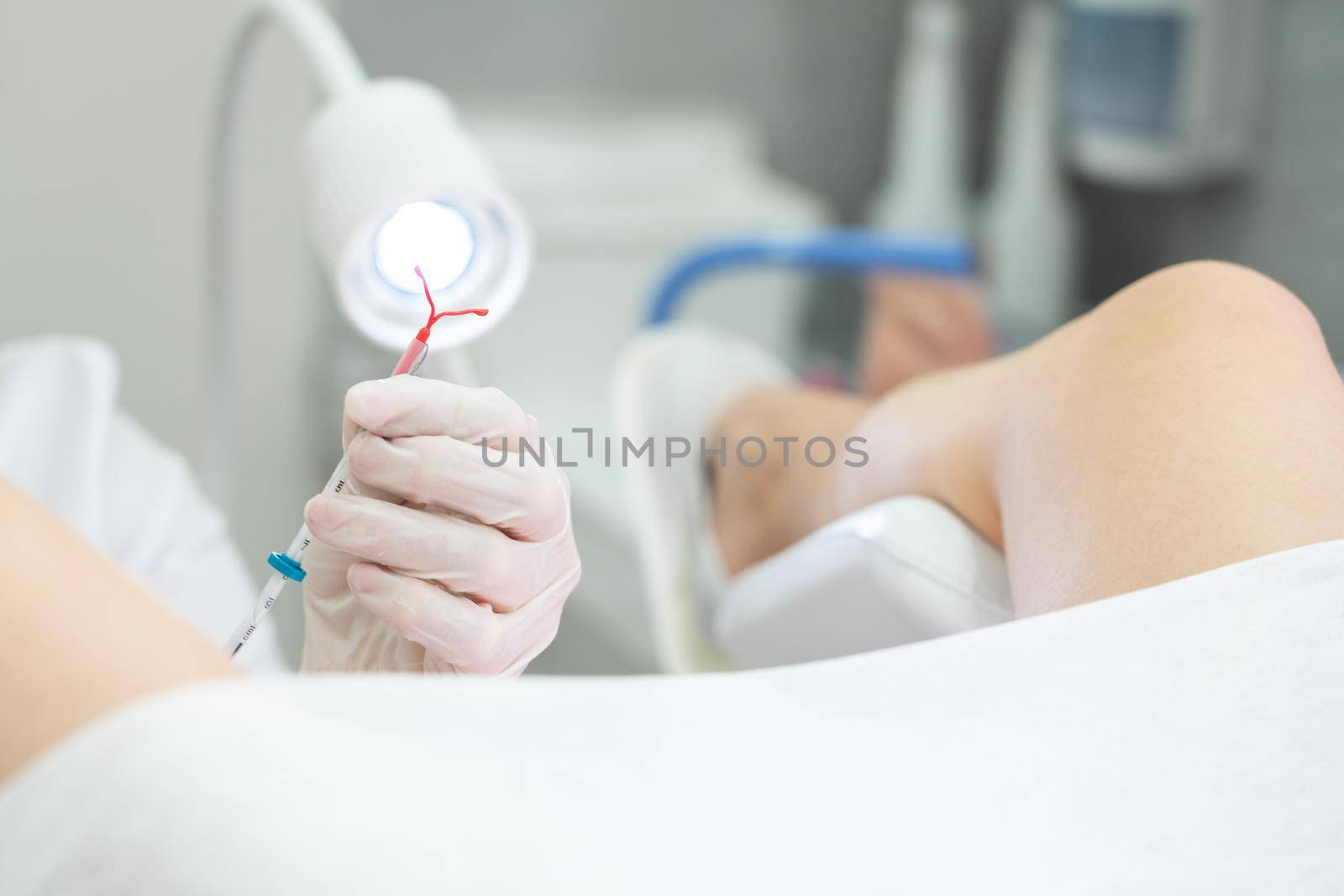 Holding an IUD birth control copper coil device in hand, used for contraception - front view