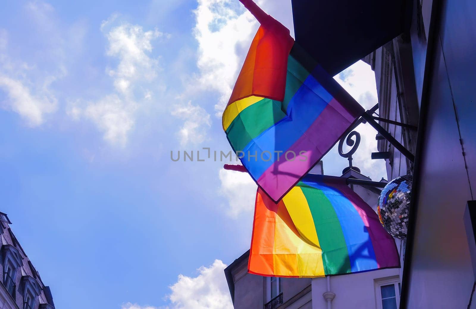 Pride rainbow lgbt gay flag being waved on sky background by Whatawin