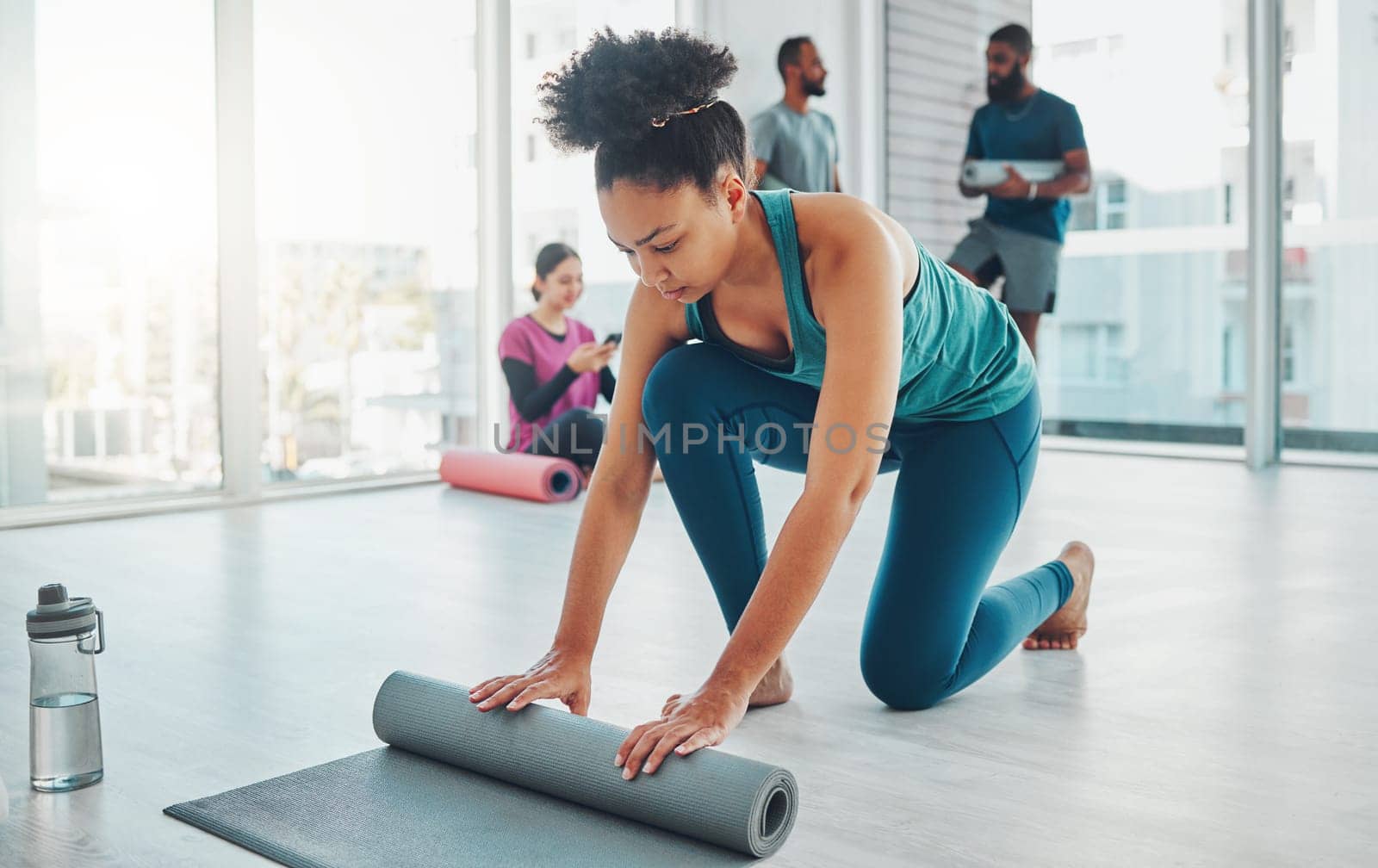 Yoga, studio and exercise mat with a fitness black woman getting ready for a wellness workout. Gym, training and zen with a female yogi indoor for mental health, balance or spiritual health.