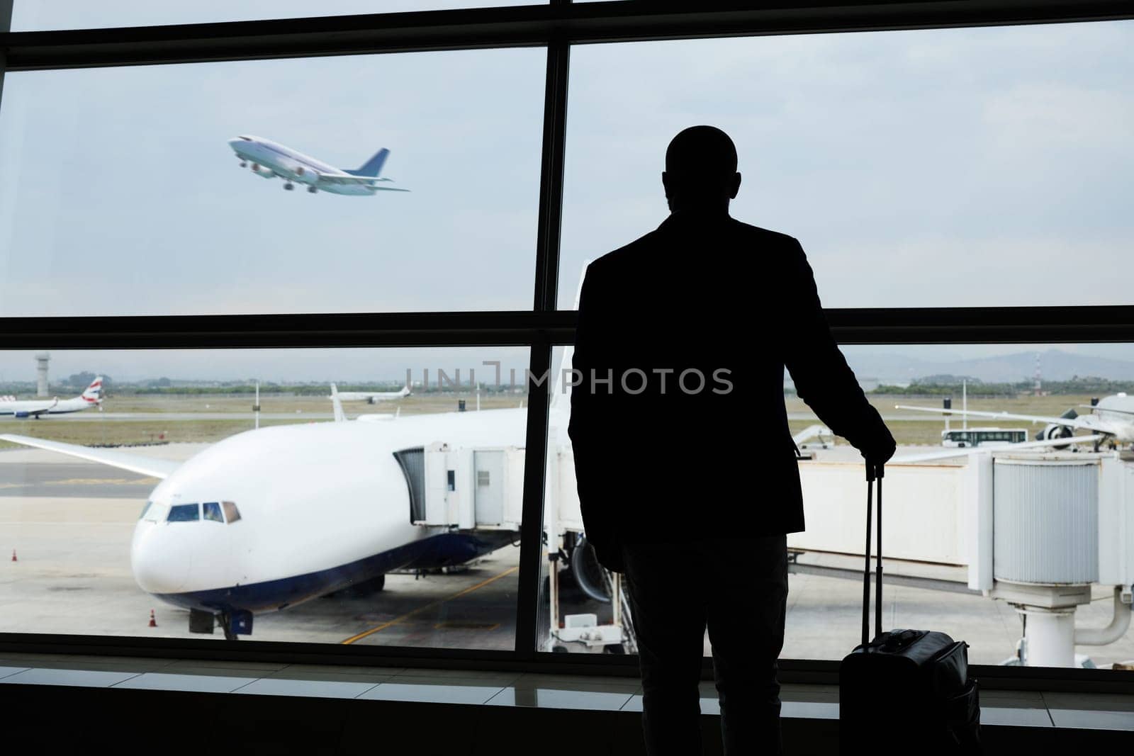 Airport, travel and silhouette business man watch plane fly, flight booking or transportation for world trip. Suitcase luggage, airport departure and back of person on holiday, vacation or journey.
