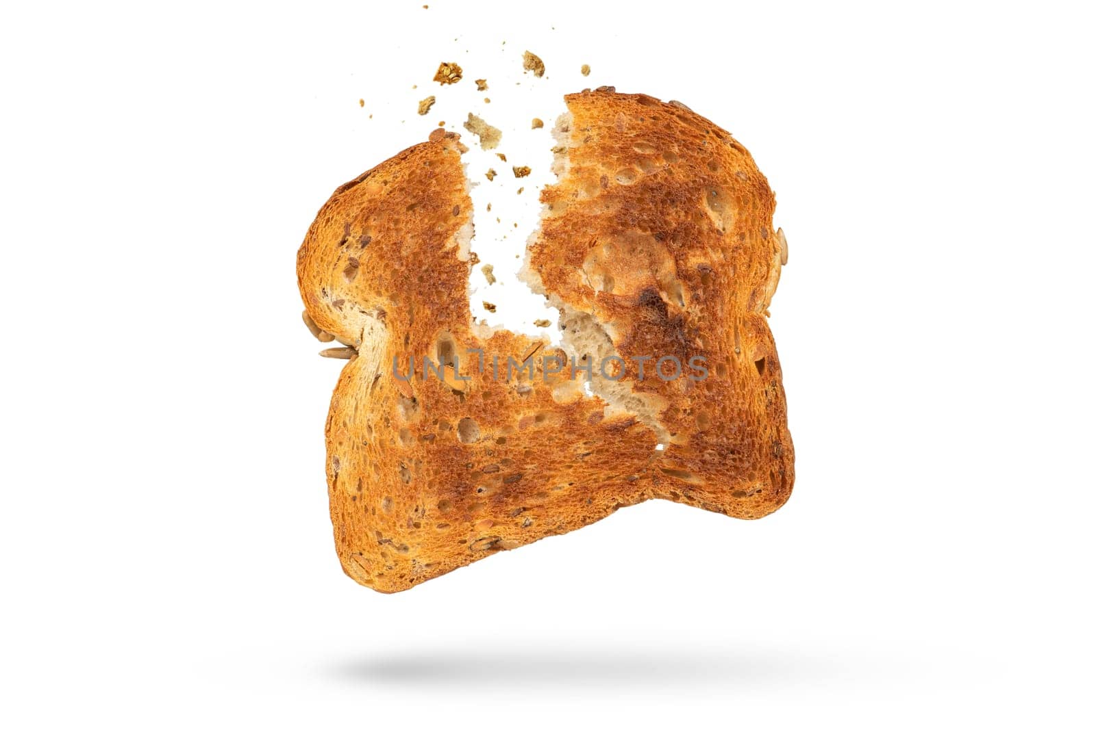 White bread slice isolate broken into 2 pieces with flying crumbs. Toaster fried bread isolated on white background. The concept of a small, dietary crispy breakfast. by SERSOL