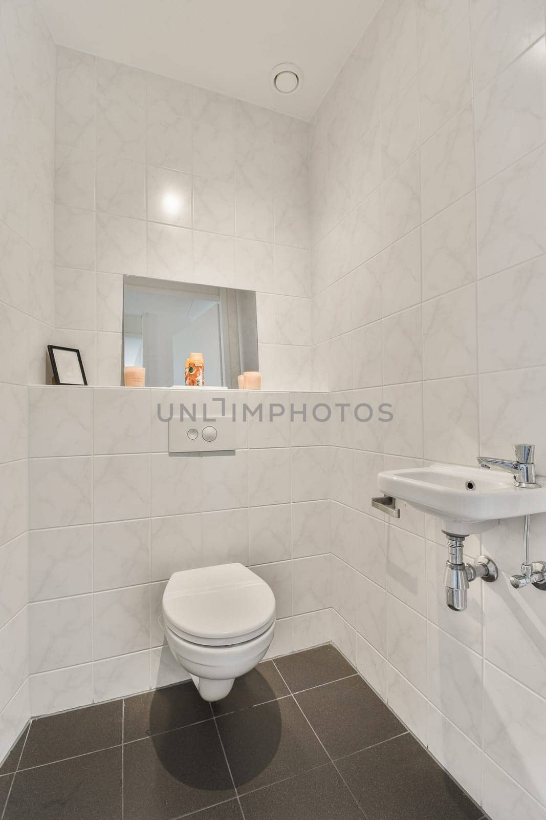 a white bathroom with a toilet and a sink by casamedia