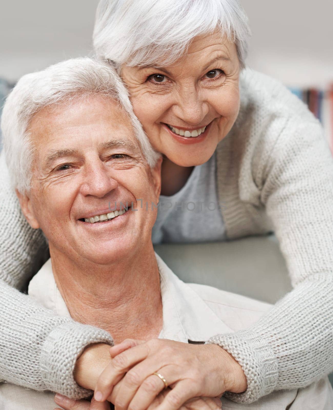 Senior, happy couple and portrait smile with hug for love, romance or embrace in relationship or marriage at home. Elderly woman face hugging man smiling for care or bonding together in retirement.