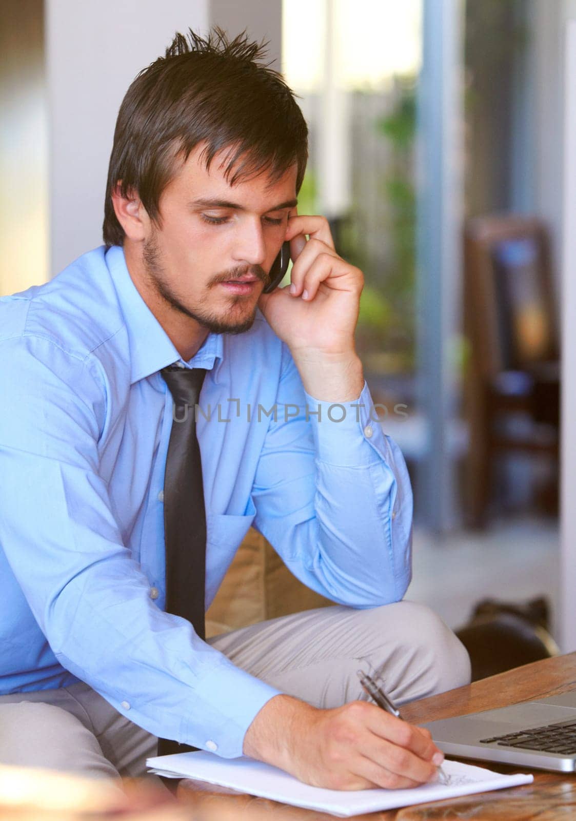 Cellphone, businessman on call and paperwork or document of schedule. Communication or consulting, man multitasking holding pen and smartphone taking notes of corporate information at office.