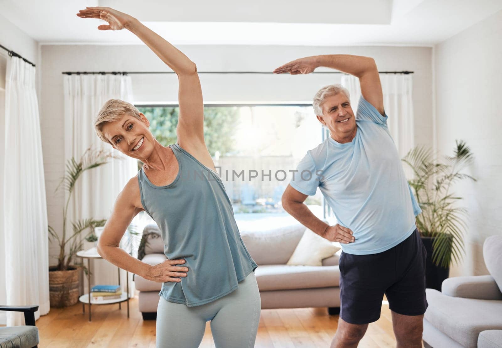 Stretching, yoga and fitness with a senior couple doing an exercise, workout or training at home. Health and wellness, lifestyle and active with a fit elderly man and woman exercising in a house.