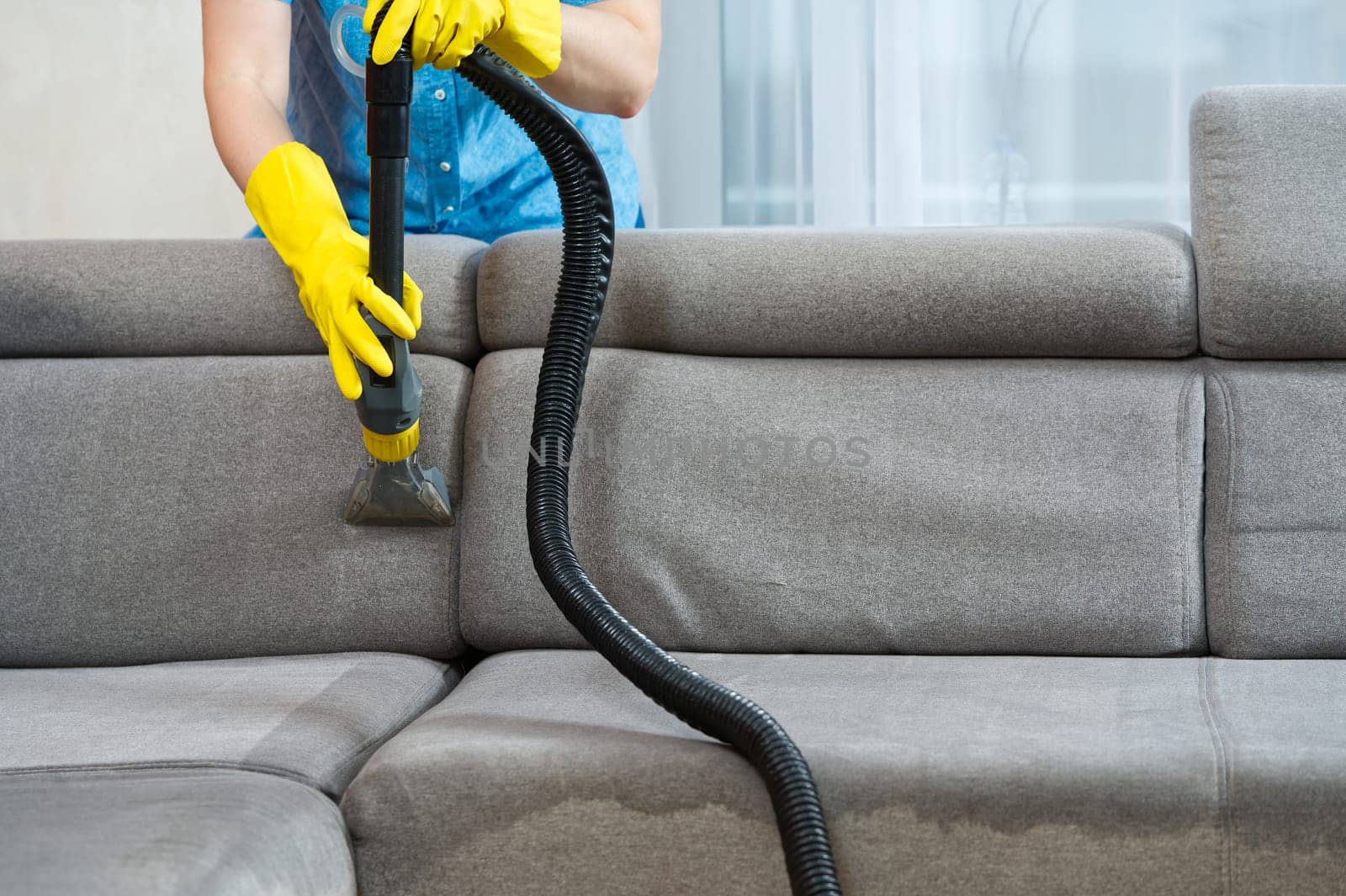 Sofa chemical cleaning with professionally extraction method. Wet textile sofa cleaning by PhotoTime
