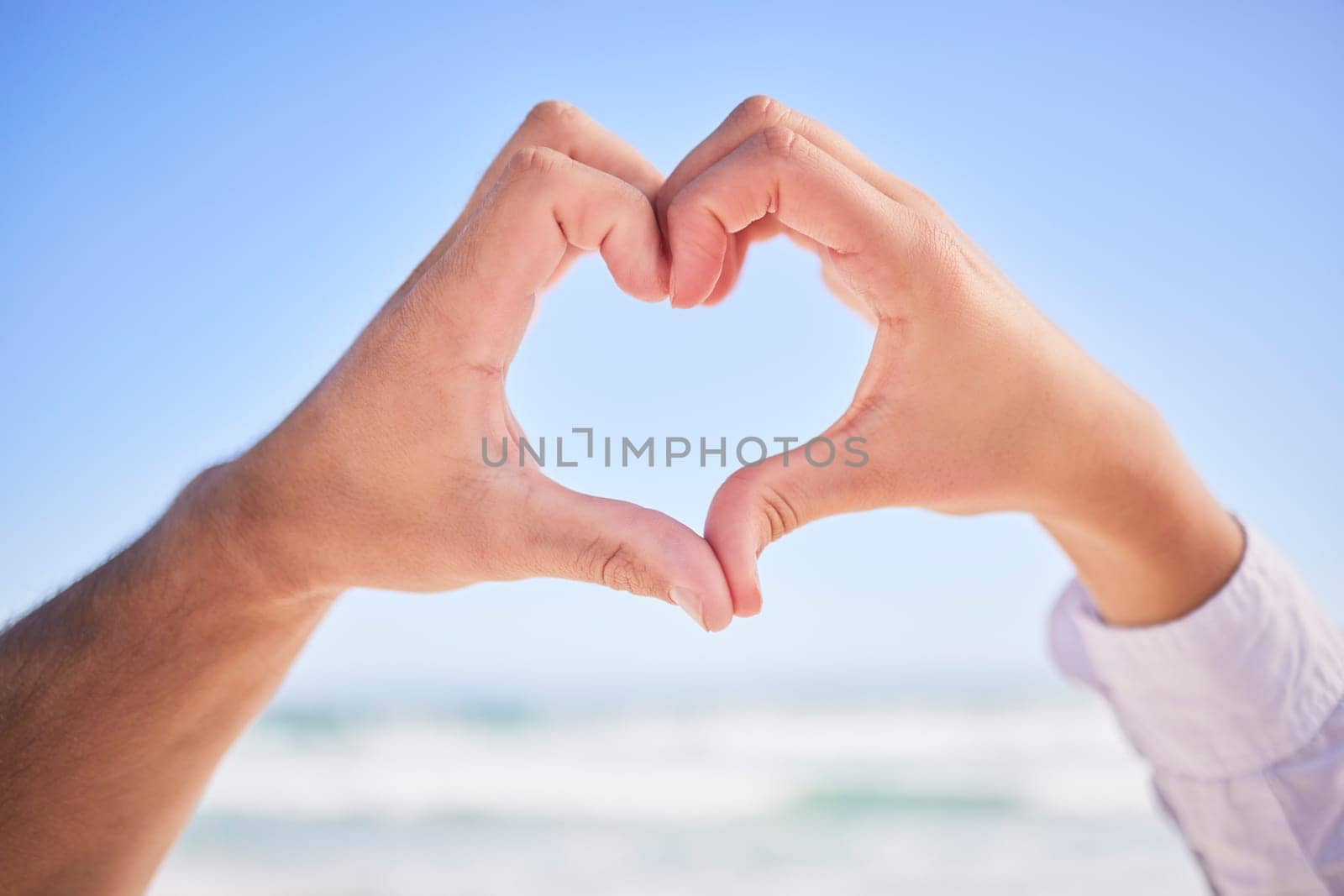Love, hands or couple at beach with heart sign on holiday vacation or romantic honeymoon to celebrate marriage Commitment, trust or lovers showing hearty shape emoji or icon in fun summer romance.