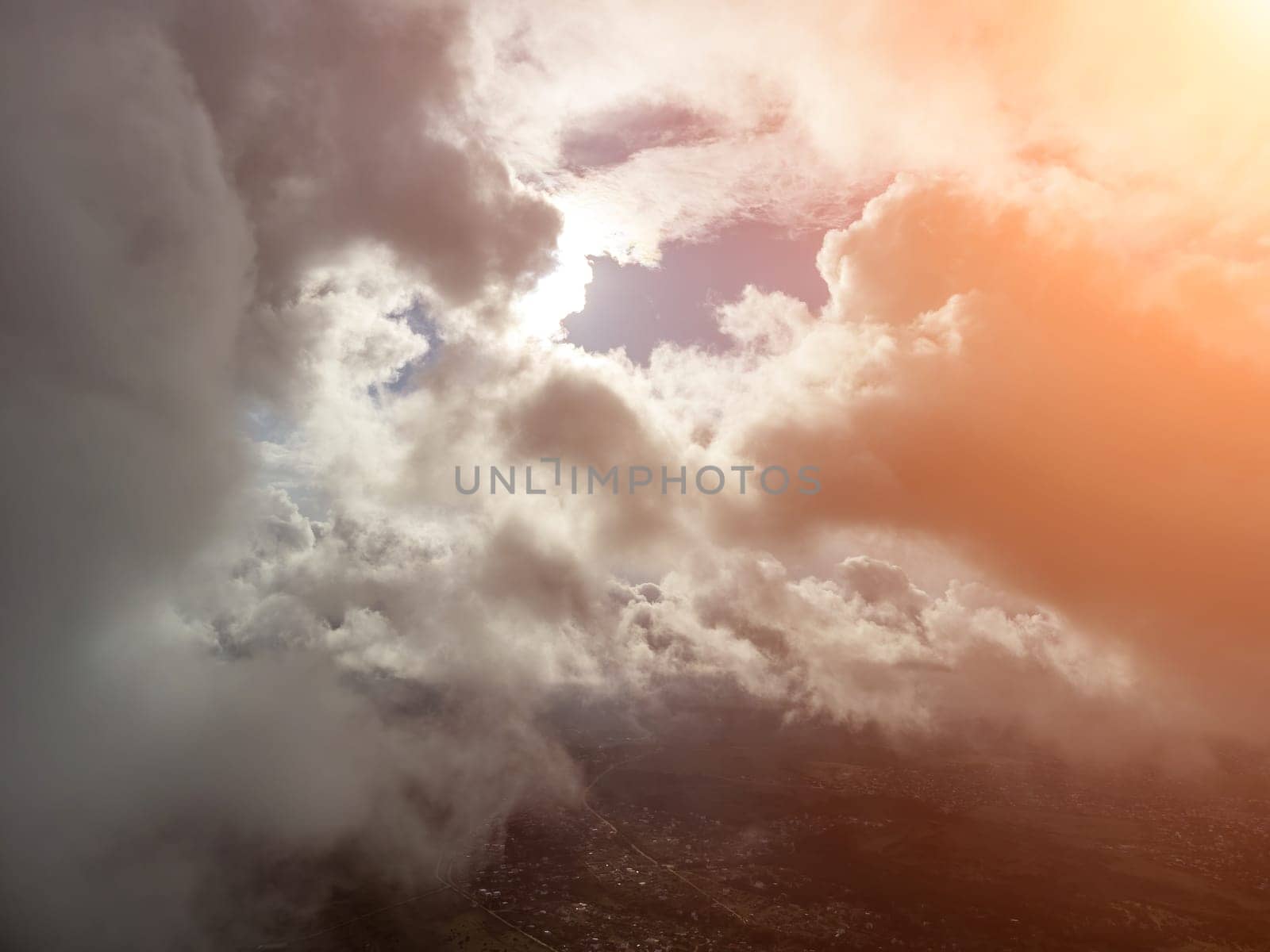 Aerial view. The drone flies over foggy and fluffy clouds. Blue sky sun and sea fog. Abstract aerial nature summer ocean sunset sea and sky background. Horizon. Vacation, travel and holiday concept by panophotograph