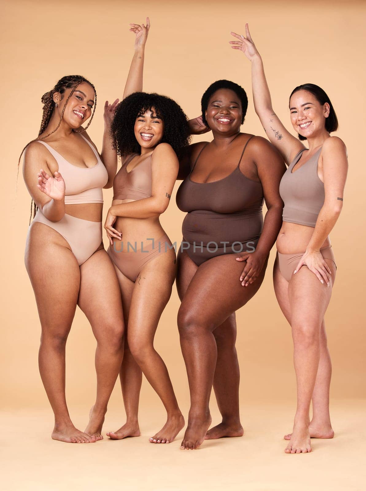 Diversity women, celebration and body portrait of friends group together for inclusion, beauty and power. Underwear model people on beige background with cellulite, pride and motivation for self love.