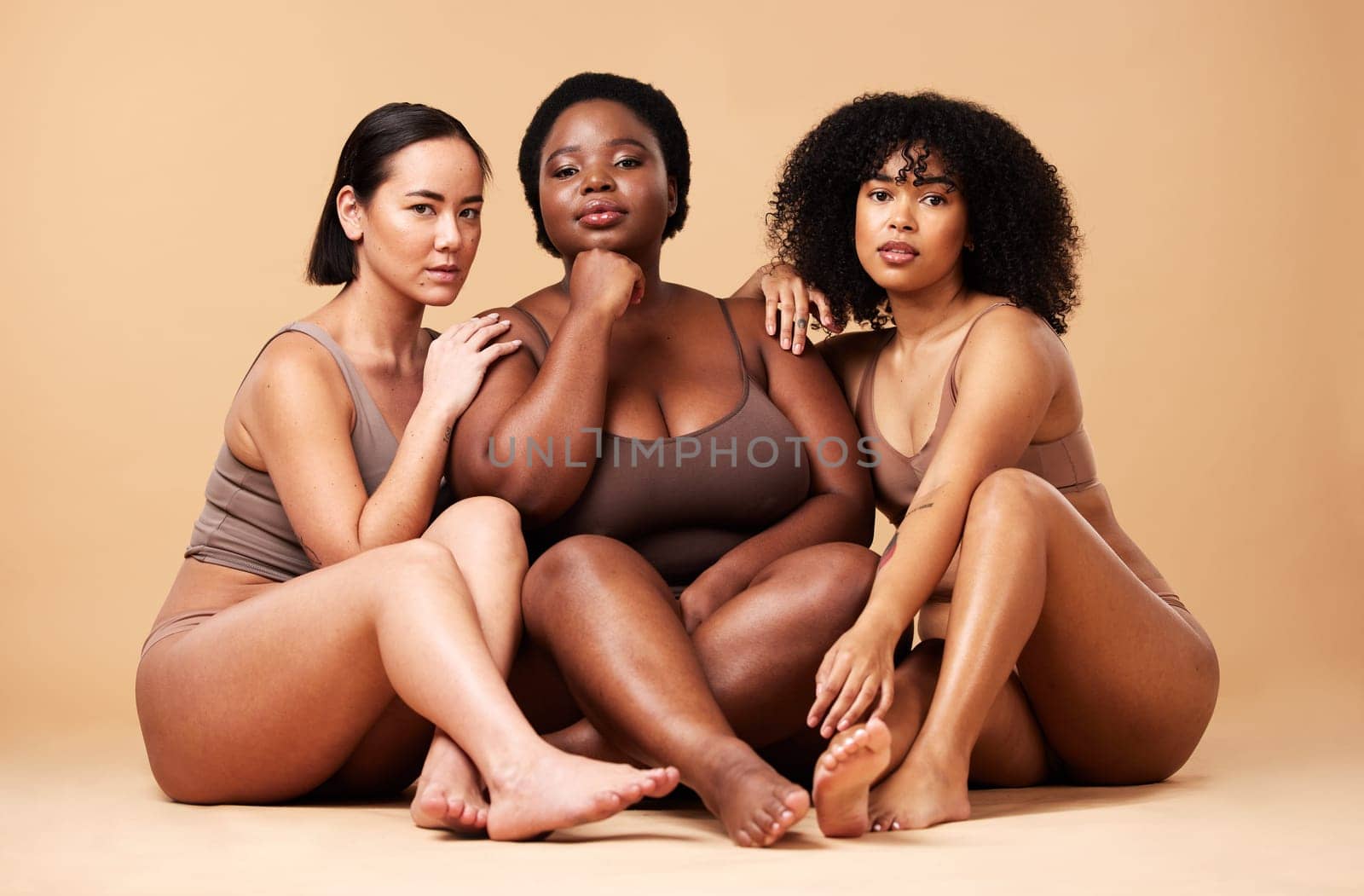 Body, skin and portrait of diversity women friends together for inclusion, beauty and power. Aesthetic model group on beige background for skincare glow, pride and motivation for underwear self love by YuriArcurs