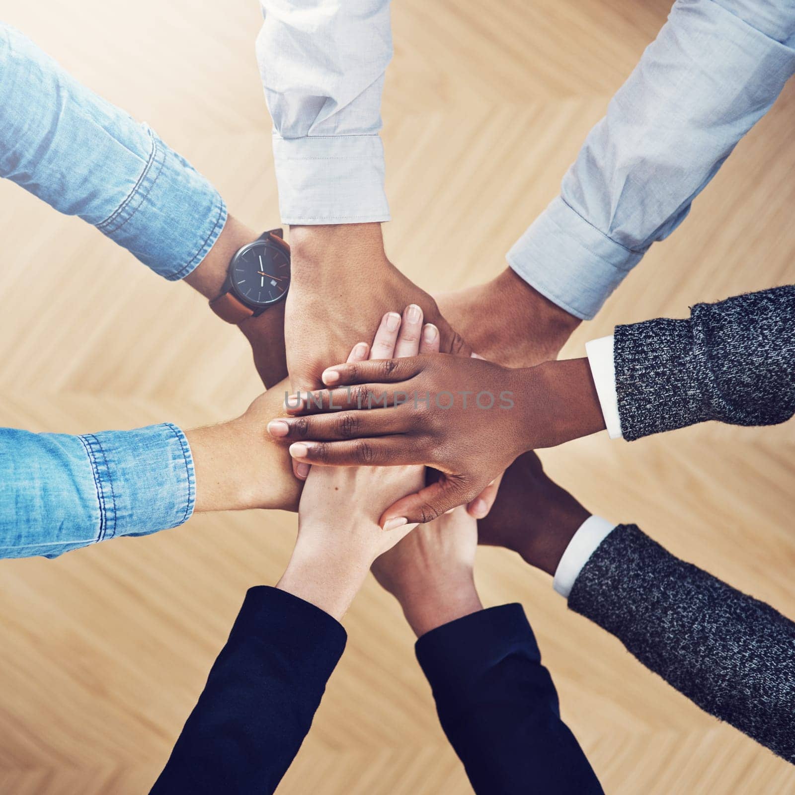 Diversity, partnership or hands of business people in support for faith, teamwork or strategy in office. Closeup, above or employees in group collaboration with hope or mission for goals together.