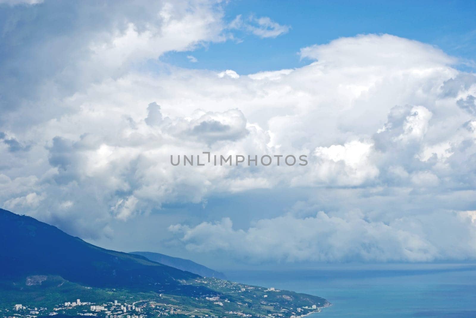 blue sea and cloudy sky over it