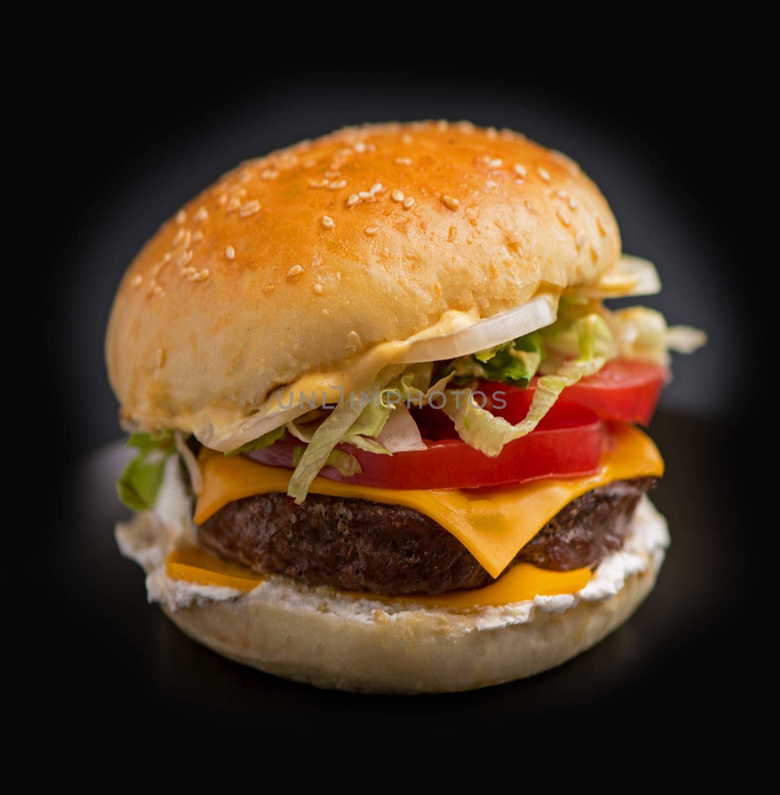 Big tasty burger with beef cutlet on a black background by aprilphoto