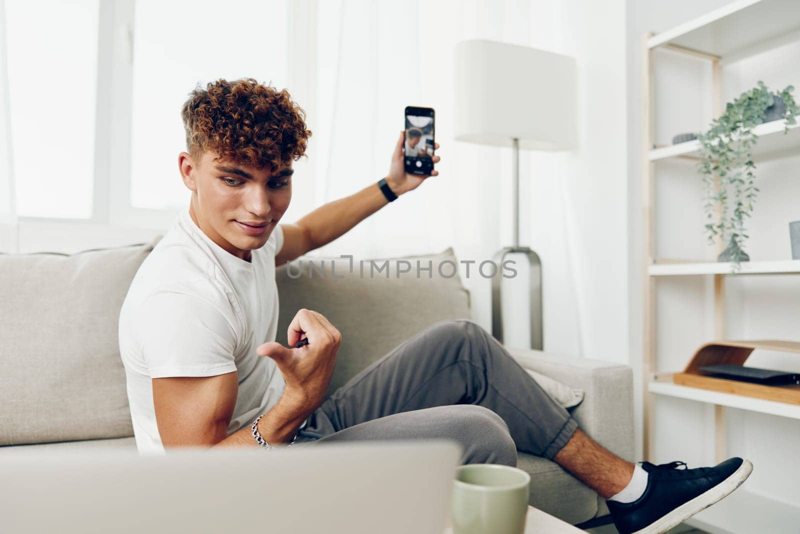 man cyberspace sofa lifestyle smart communication sitting smile holding mockup message person male by SHOTPRIME