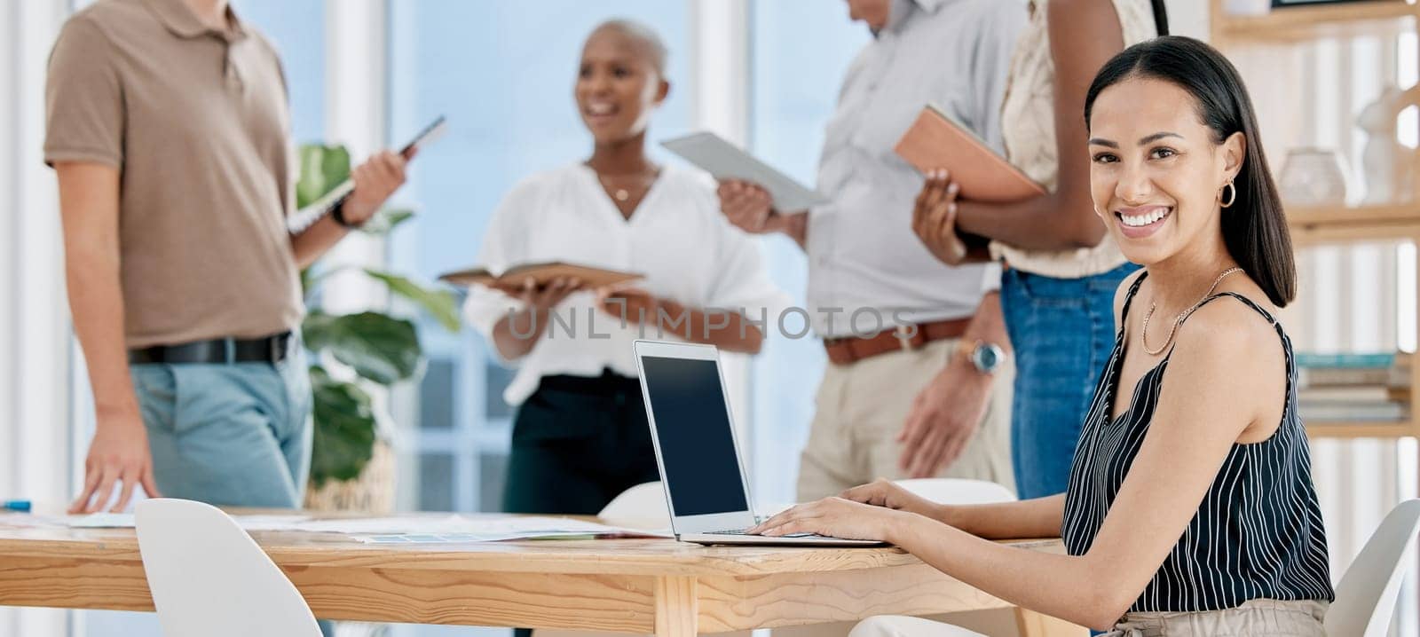 Laptop, meeting and portrait of woman in the office planning a marketing project with team. Happy, smile and creative female employee doing research on computer for advertising strategy in workplace