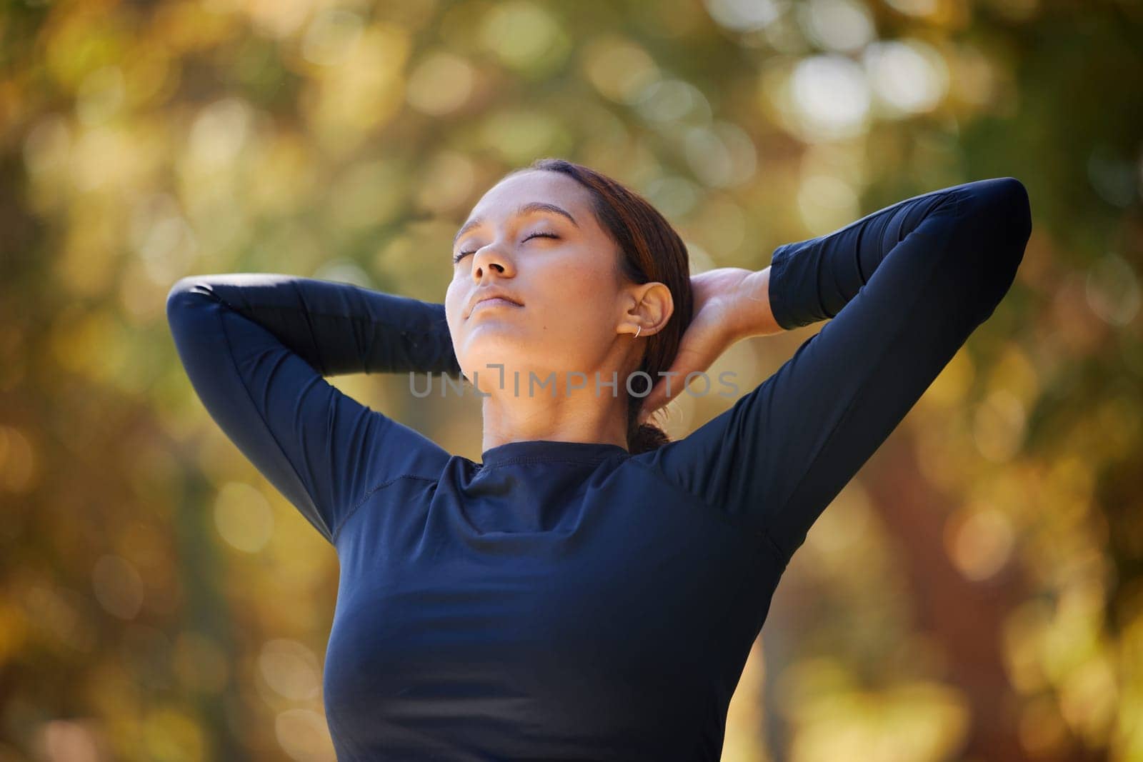 Black woman in outdoor park, breathing in natural fresh air in and morning fitness in Cape Town. Healthy spiritual wellness, zen breathe in meditation and young lady stretching arms with eyes closed.