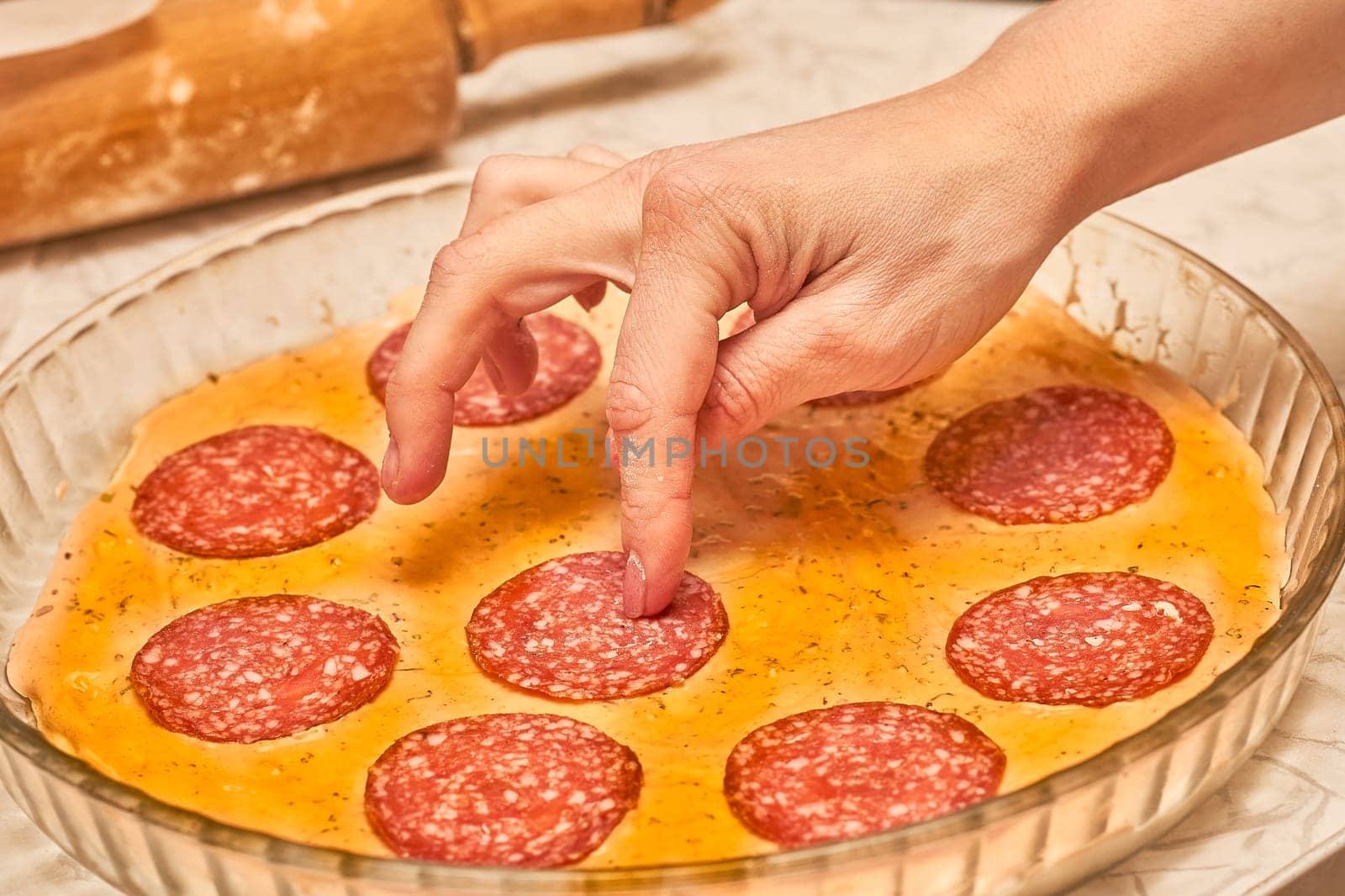a dish of Italian origin consisting of a flat, round base of dough baked with a topping of tomato sauce and cheese, typically with added meat or vegetables