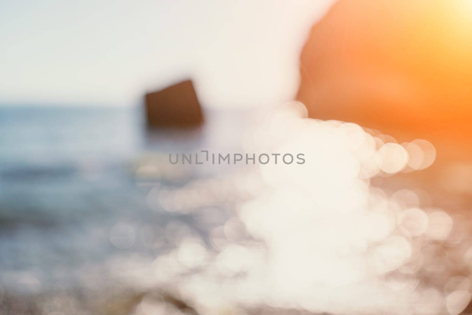 Abstract nature summer ocean sunset sea background. Small waves on water surface in motion blur with bokeh lights from sunrise. Holiday, vacation and recreational background concept. by panophotograph