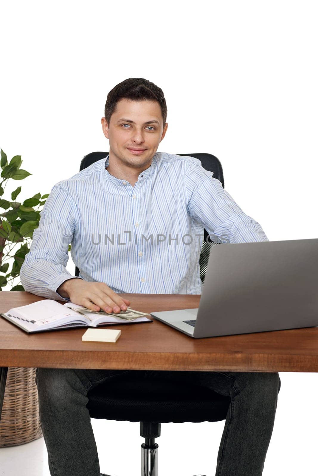 young man using laptop computer for online work at table on white background
