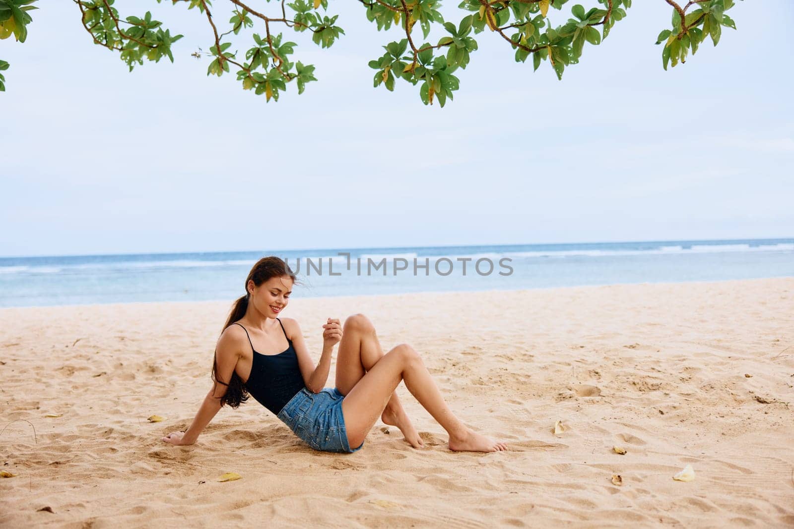 outdoor woman vacation white ocean freedom hair young sea sitting holiday hair relax nature tan beach carefree attractive travel smile long sand