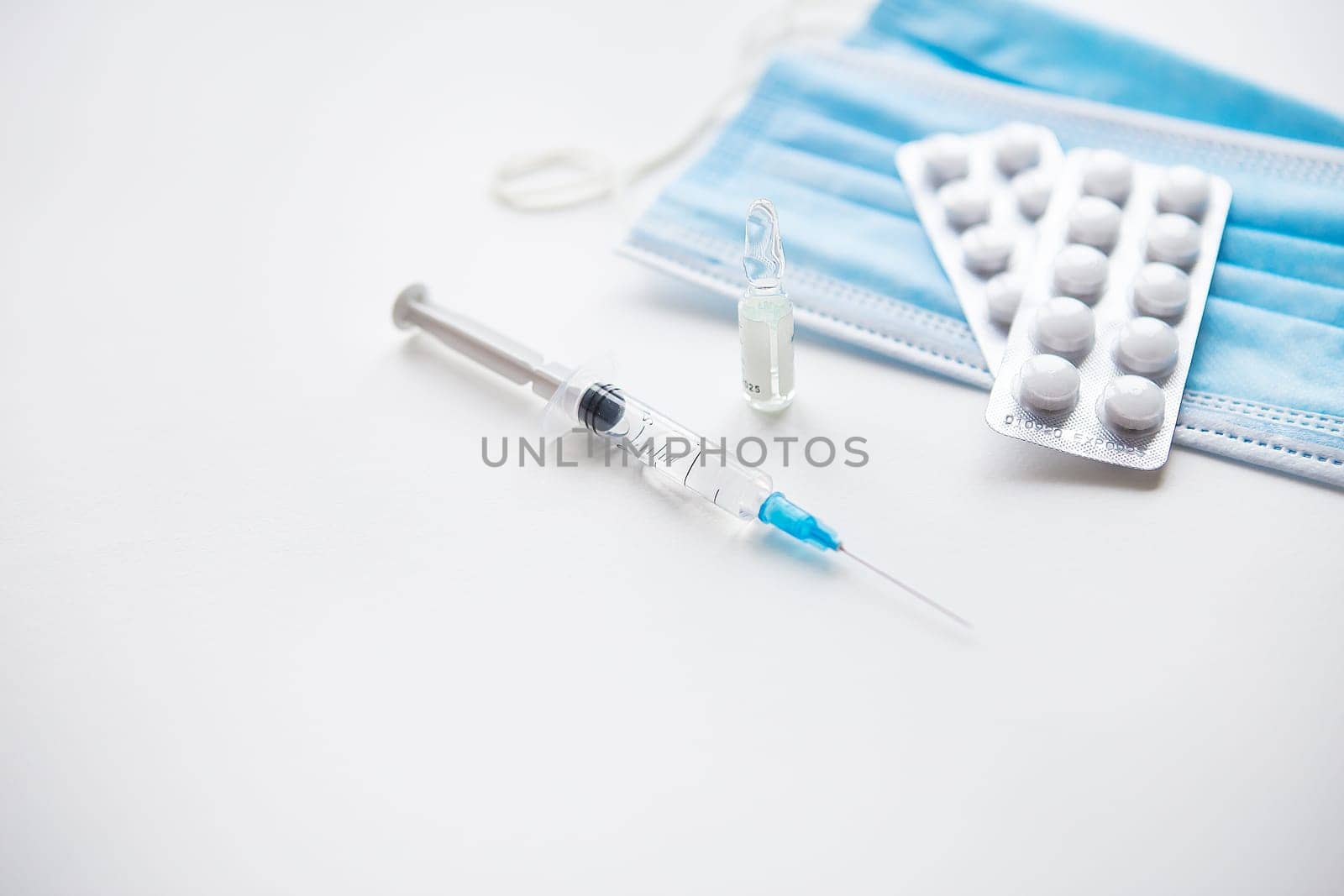 Preparation for vaccination against covid-19. Syringe, vaccine, pills, medical mask