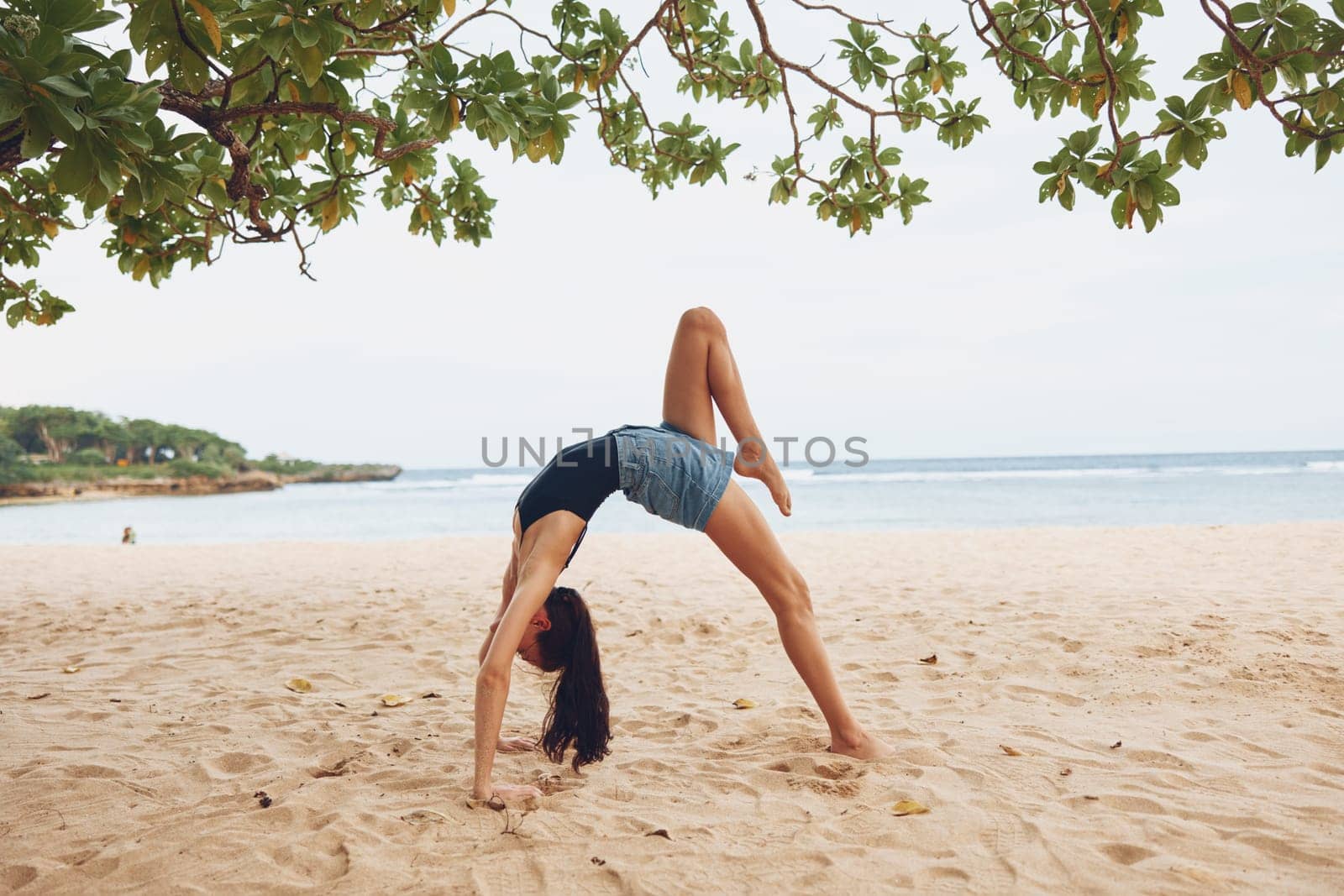 woman active fitness bridge calm exercise lifestyle healthy bikini pose training young sea beauty gymnastics ocean beach practice sport female yoga