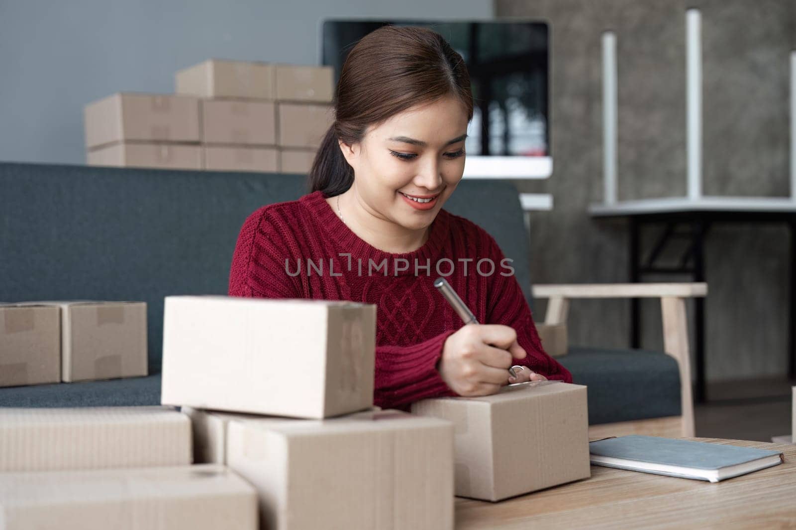 woman start small business and successful SME entrepreneurs A woman works from home delivering parcels online. SME delivery concept and packaging.