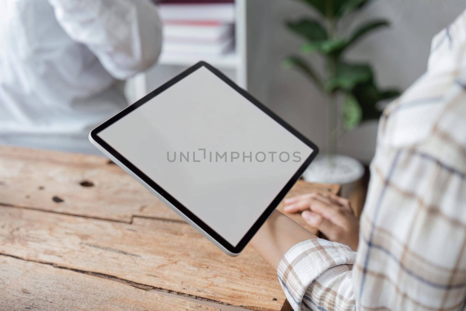 Asian teenage woman study working mockup screen tablet technology, at library, woman study holding tablet with blank screen, female hands texting connect gadget, communication wifi internet.